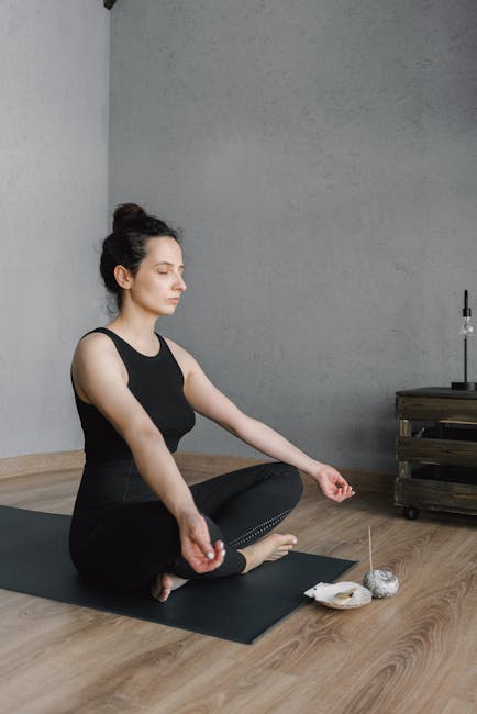 Smiling person with closed eyes meditating in a bright, modern room
